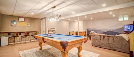 Basement game room with billiards and foosball tables, PacMan arcade, and XBox.