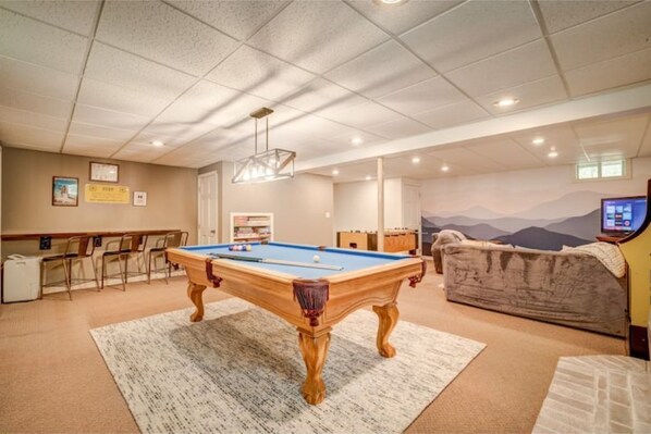 Basement game room with billiards and foosball tables, PacMan arcade, and XBox.