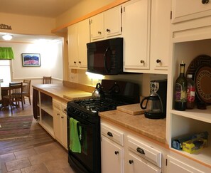 Kitchen with pots, pans, spices, and other cooking essentials.