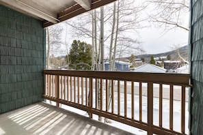 The private covered balcony offers mountain and neighborhood views.