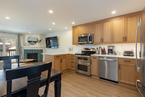 The updated kitchen offers quartz countertops, stainless steel appliances, and plenty of counter space for meal prep.