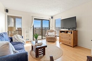 living room with sliding door that leads to large deck