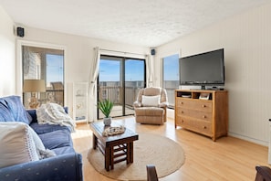 living room with sliding door that leads to large deck 