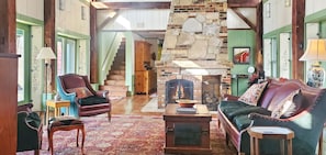 Living room with a wood burning fireplace.