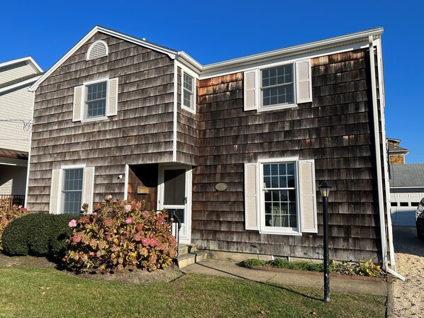 Charming 4-bedroom Colonial with a driveway, and a garage to store beach stuff.