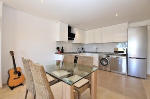 View of the open kitchen with the dining area for four guests