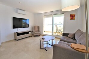 Modern and bright lounge area with air conditioning and access to the terrace