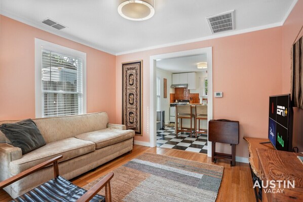 Cozy living room with sofa, smart tv, and tray tables