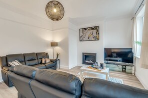Spacious living room with ornate cornice and ceiling rose