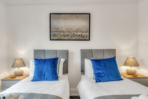 Spacious double bedrooms with bedside tables and wardrobe