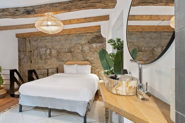 Dream sweetly in our plush bed with bespoke natural accents and serene lighting.
