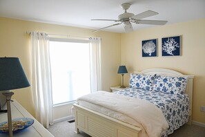 This bedroom, located right off the entryway, has a Cozy Queen Bed.