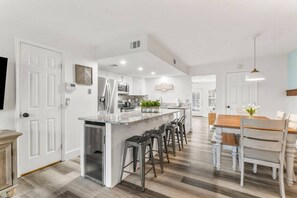 Stainless steel kitchen with wine fridge in the granite island