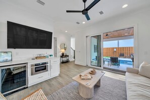 The main floor den and kitchenette provides an ideal setting with accordion doors leading to the covered patio.