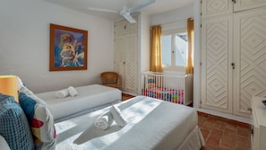 Main house - Bedroom with two single beds + crib and ceiling fan. Linen included! #bedroom #comfort