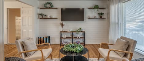 Step through the front door to reveal a modern living room, with nods to the home’s rustic roots.  This charming lounge area has plenty of space for your family to gather without feeling crowded, yet remains snug and intimate.