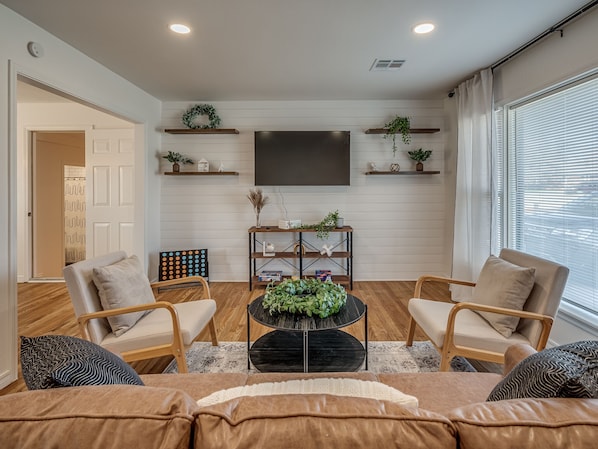 Step through the front door to reveal a modern living room, with nods to the home’s rustic roots.  This charming lounge area has plenty of space for your family to gather without feeling crowded, yet remains snug and intimate.