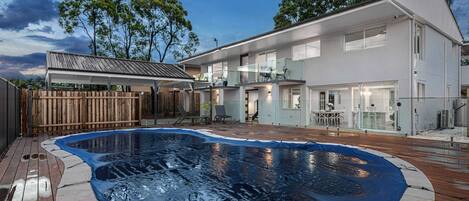 Welcome to our spacious home in the tranquil suburb of Graceville, Brisbane. Enjoy multiple living areas, including a cozy fireplace for cooler nights, and take a dip in the big outdoor pool on hot summer days.