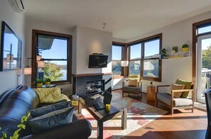 Family room with gas fireplace (seasonal) and view of the lake