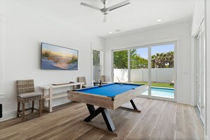 Game room with pool table, flat screen, arcade games