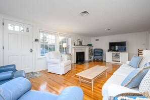 Sunny living space adorned in shiplap walls - 3 Shore Road Extension West Harwich Cape Cod - A Shore Thing - New England Vacation Rentals