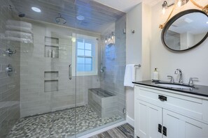 Zero-entry extra wide shower with multiple shower heads (including rain!), bench seating and a grab bar in this full bathroom - 3 Shore Road Extension West Harwich Cape Cod - A Shore Thing 
 - New England Vacation Rentals