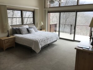 Primary bedroom with a bathroom and a view 