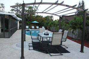Enjoy a pool side lunch or dinner or lounge by the pool in the private backyard