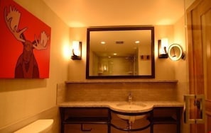 The spacious and modern bathroom features stylish decor and accessible features.
