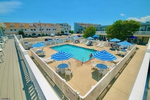 Community pool with plenty of seating! just downstairs from the condo!