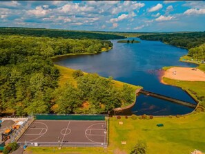 Community main lake with beach access & basketball court.