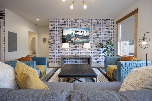 Brighten up your space with a pop of color! This living room is decked out in beautiful blue and yellow furniture, ideal for entertainment nights in front of the TV