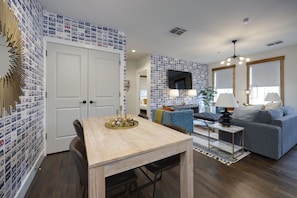 A cozy living room set up with a modern table and chairs, perfect for enjoying meals or getting work done from home.