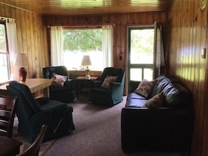 Cedar Cottage living area with screen door leading to the water!