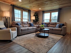 Living room features two sofas and a recliner