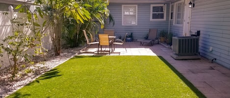 gated backyard with patio and turf