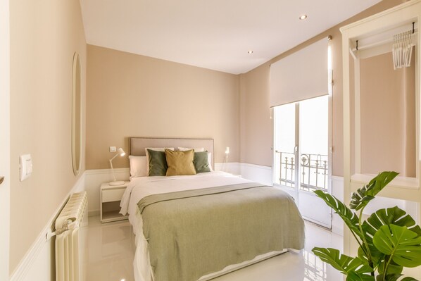 Main view of one of the bedrooms with a double bed and exterior window