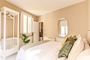 Main view of one of the bedrooms with a double bed and exterior window