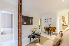 Main view of the living room with Smart TV and dining area