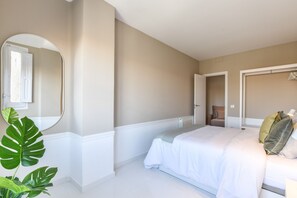 Main view of one of the bedrooms with a double bed and exterior window