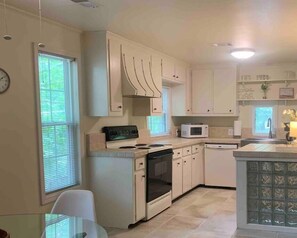 Fully equipped kitchen with forest views for peaceful meal prep.