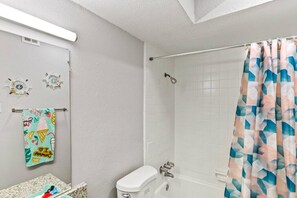 Shower area with bath tub and shower curtains