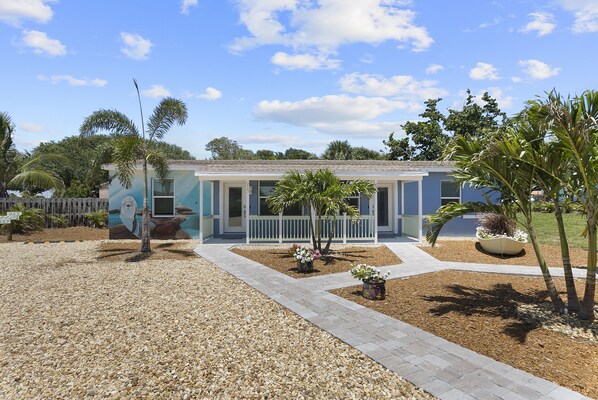 Beautifully landscaped front yard with a rock driveway, parking for one car per unit. Dolphin building, 215 Dolphin is the right hand side unit. 