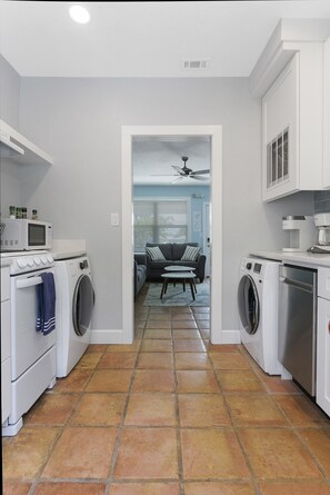 Brand New Kitchen with apartment-size appliances makes for extremely efficient use of a small space.  24" front load Samsung washer and dryer, microwave, 18" dishwasher, 20" four burner stove.