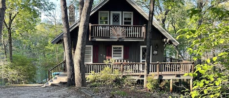 Cozy Cabin with a lower wrap-around porch and two upper porches off bedrooms.