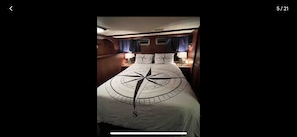 Master cabin w/ queen bed, tv, guest clothing storage, a/c & en-suite bathroom