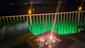 Comfy outdoor sofa with cozy firepit to watch marine life with underwater lights