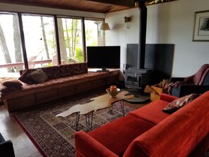 Confortable well appointed living area, wood stove, view of lake, walk out porch