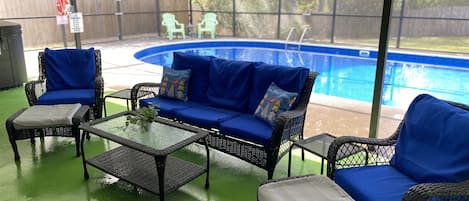 Screened in Pool, wall mounted TV, Grill, Dining Table, lounge chairs, couch 
