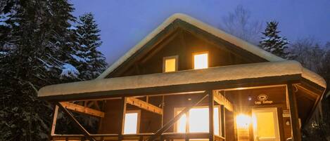 Log cottage exterior (winter night)
